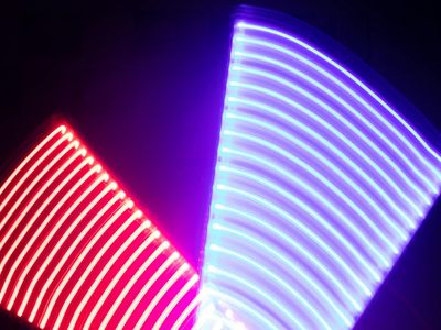 Neon patterns of energy flowing through dark space background